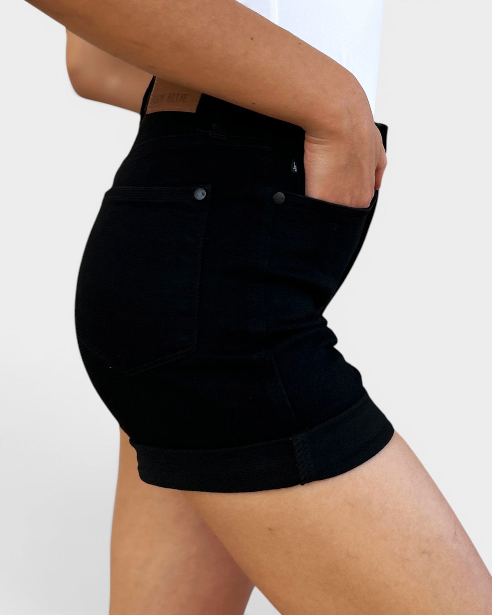 Person wearing black shorts on a white background