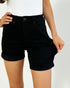 Person wearing black shorts on a plain background