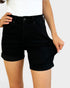 Person wearing black shorts on a plain background