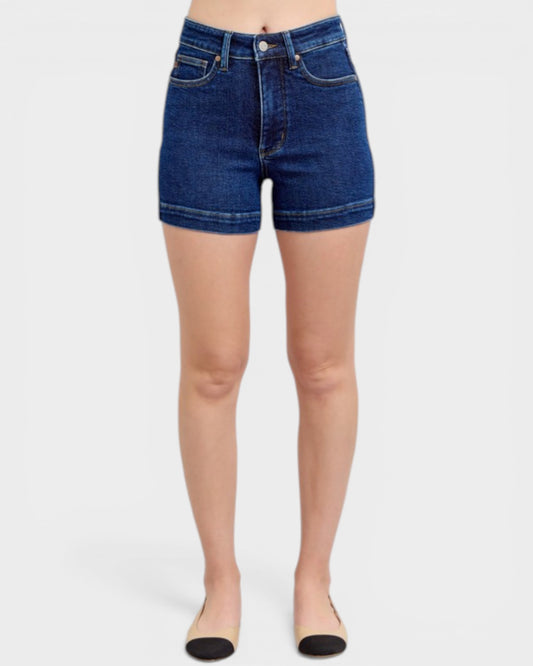 Denim shorts worn by a person on a white background