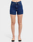 Denim shorts worn by a person on a white background