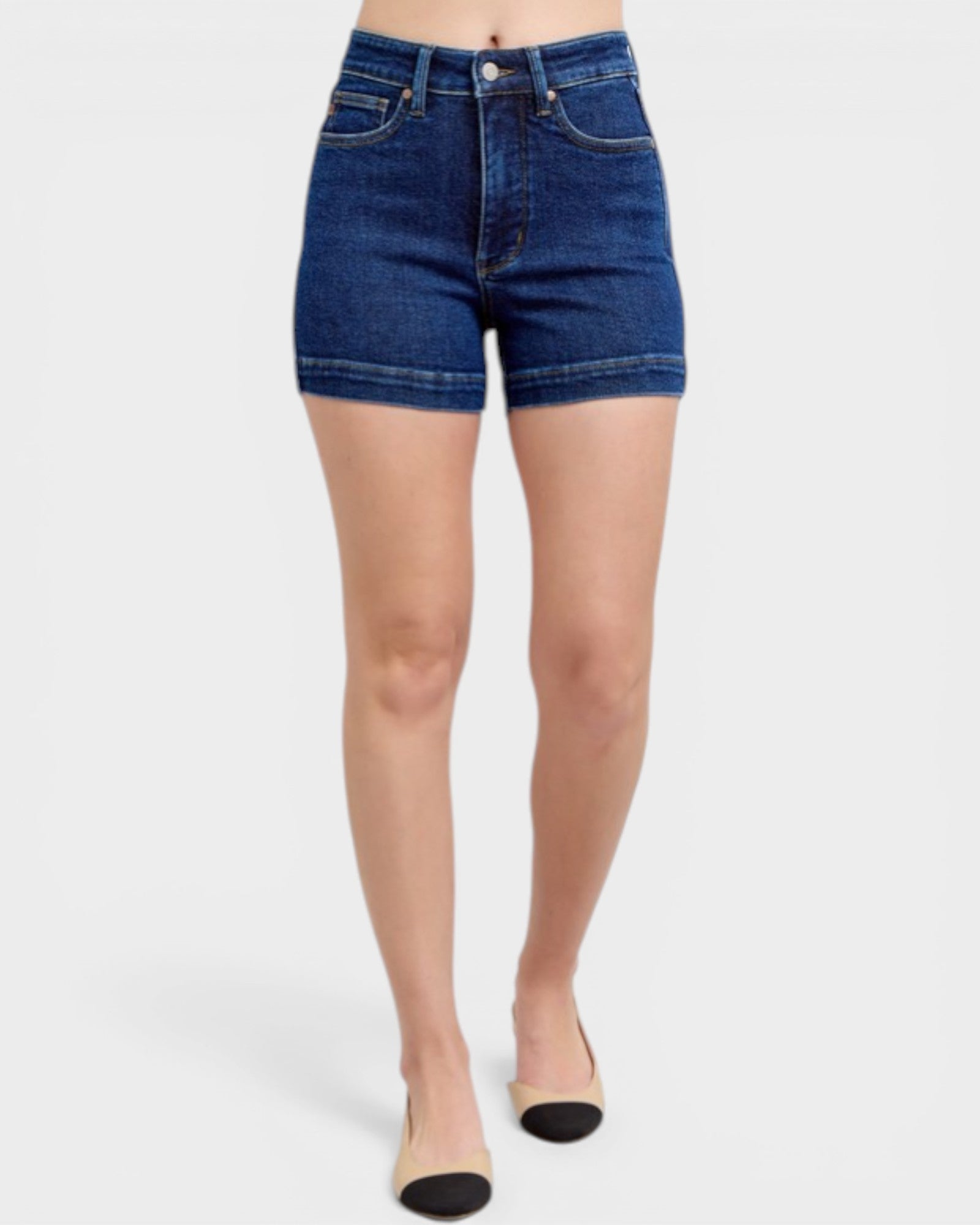 Denim shorts worn by a person on a white background