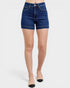 Denim shorts worn by a person on a white background