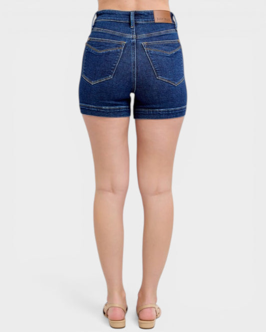 Denim shorts worn by a person on a white background