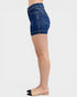 Denim shorts worn by a person on a white background