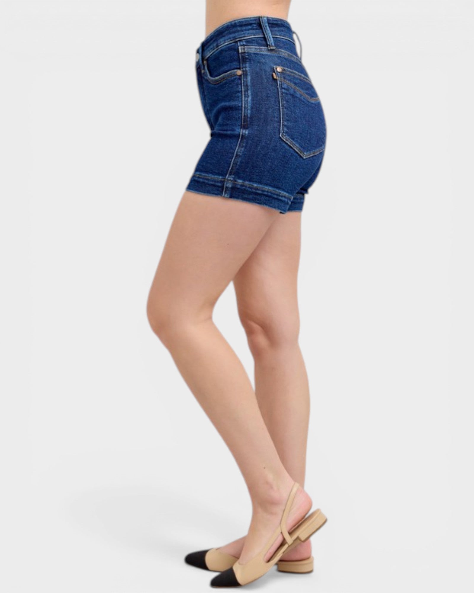 Denim shorts worn by a person on a white background