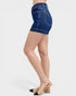 Denim shorts worn by a person on a white background