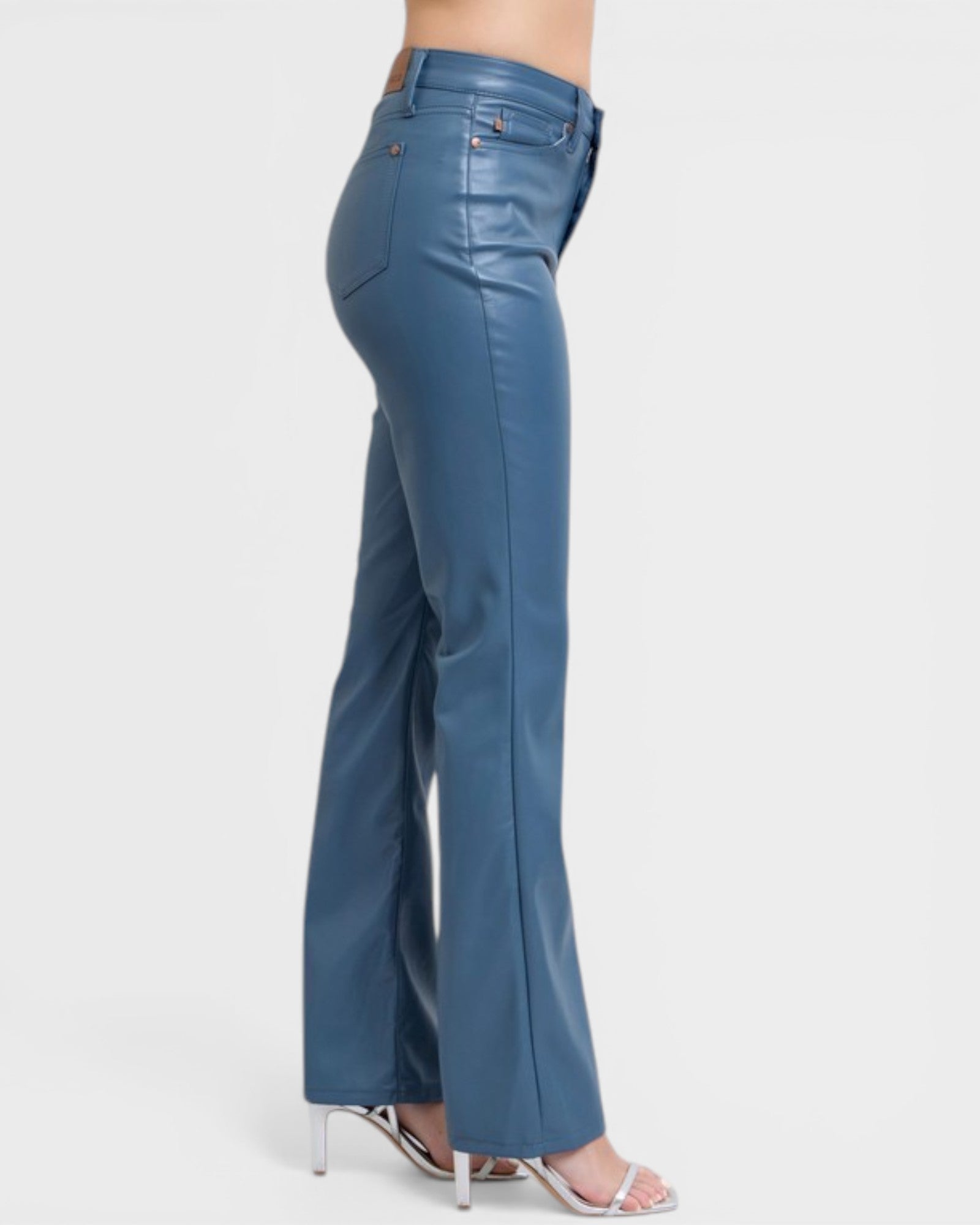 Blue flared jeans worn by a person on a white background
