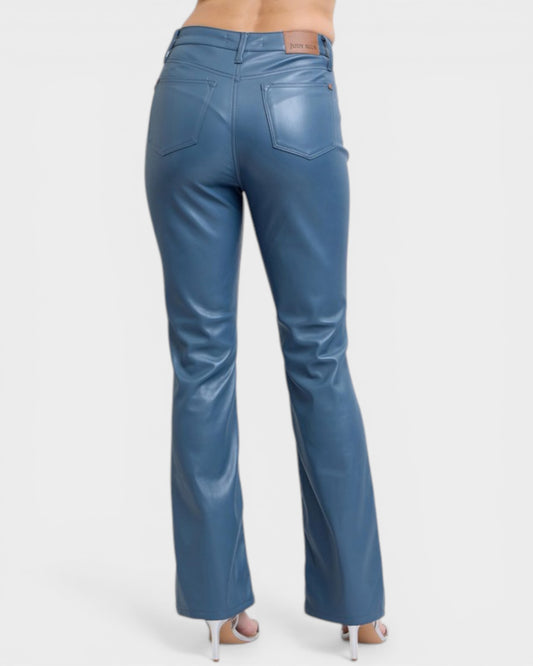 Blue jeans worn by a person on a white background