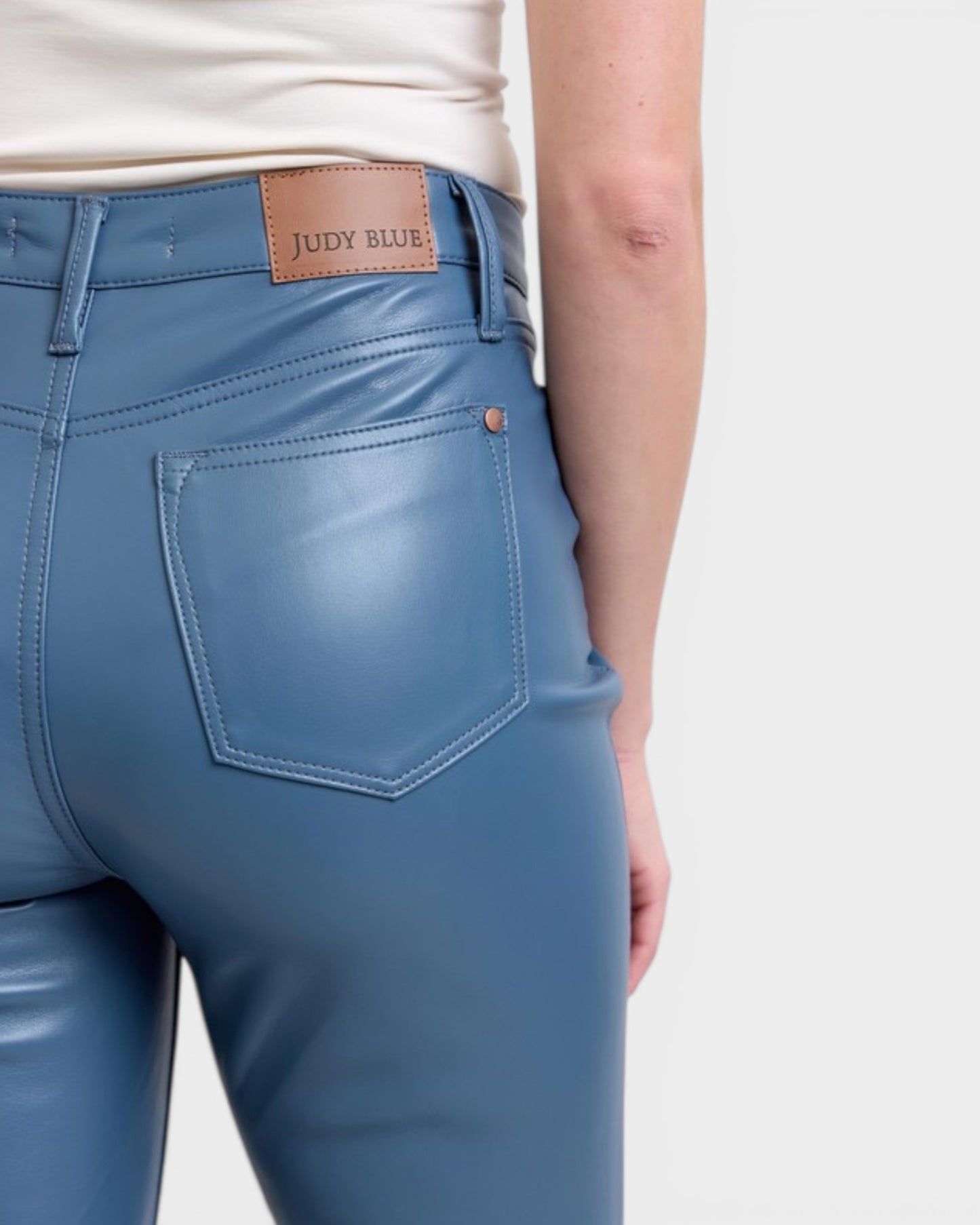 Blue pants with a brand label on a white background