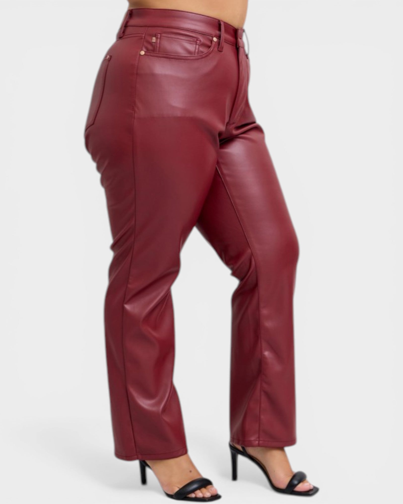 Maroon leather pants worn by a person on a white background
