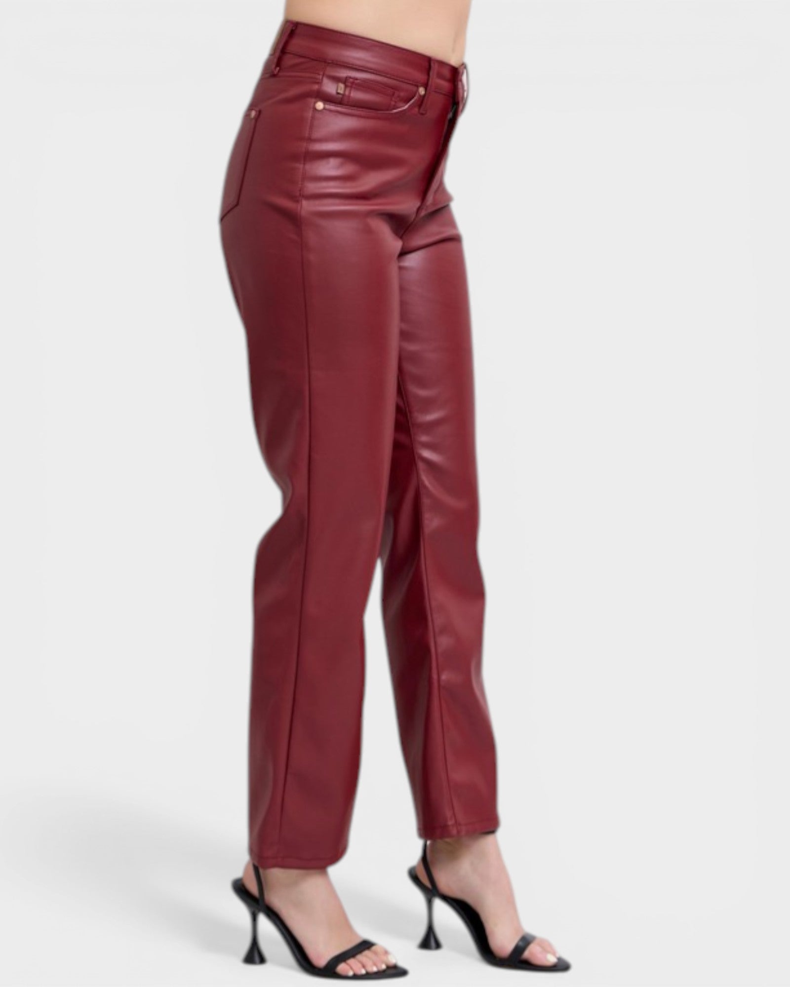 Maroon leather pants worn by a person on a white background