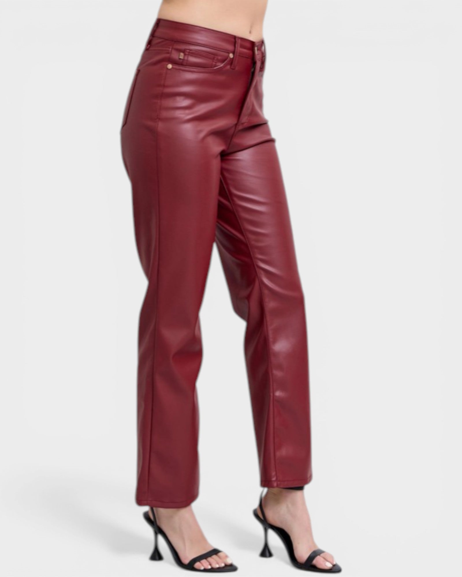 Maroon leather pants worn by a person on a white background