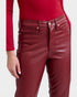 Red leather pants worn by a person on a white background