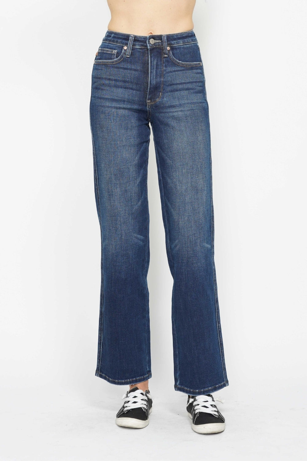 Blue jeans worn by a person on a white background