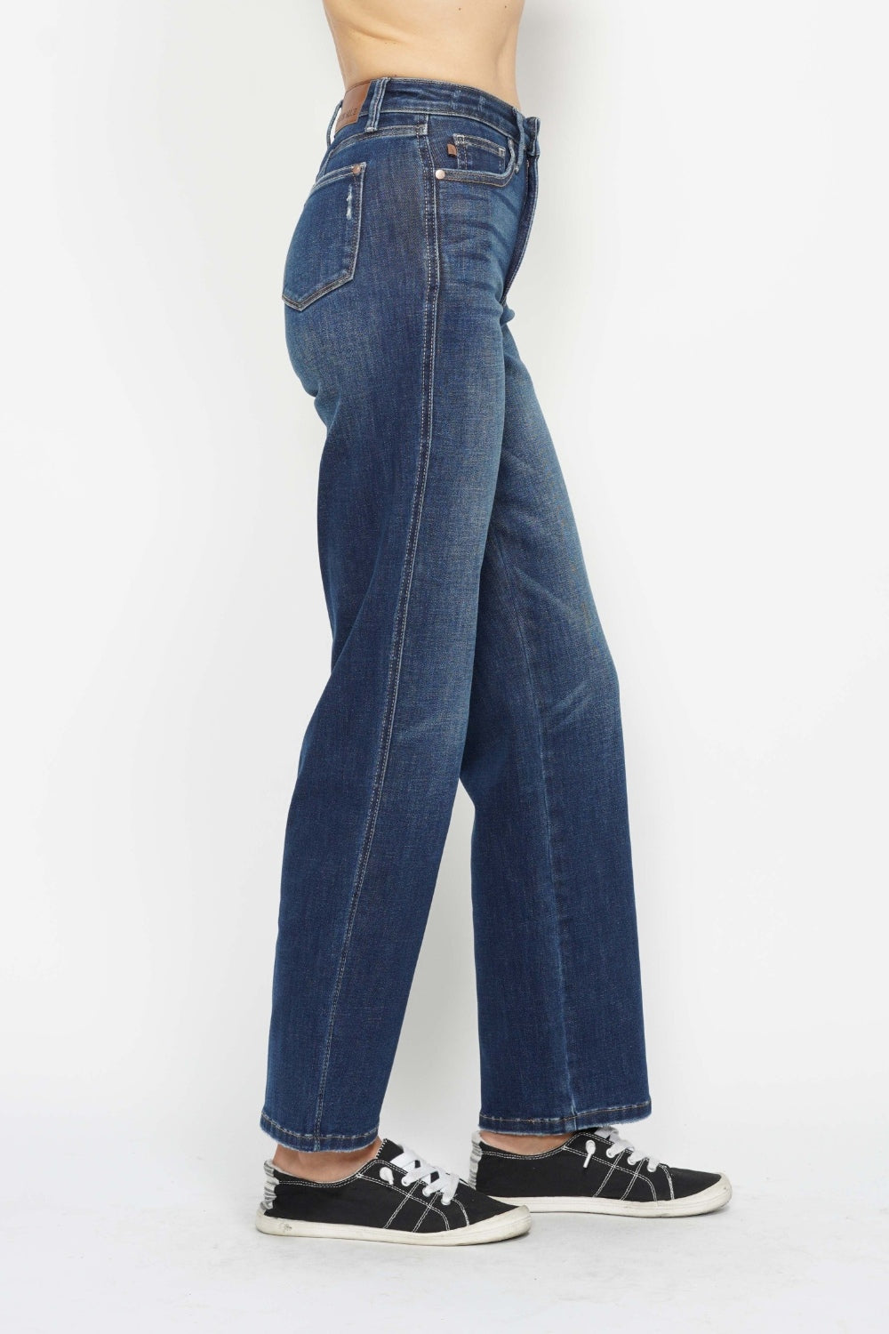 Person wearing blue jeans on a white background