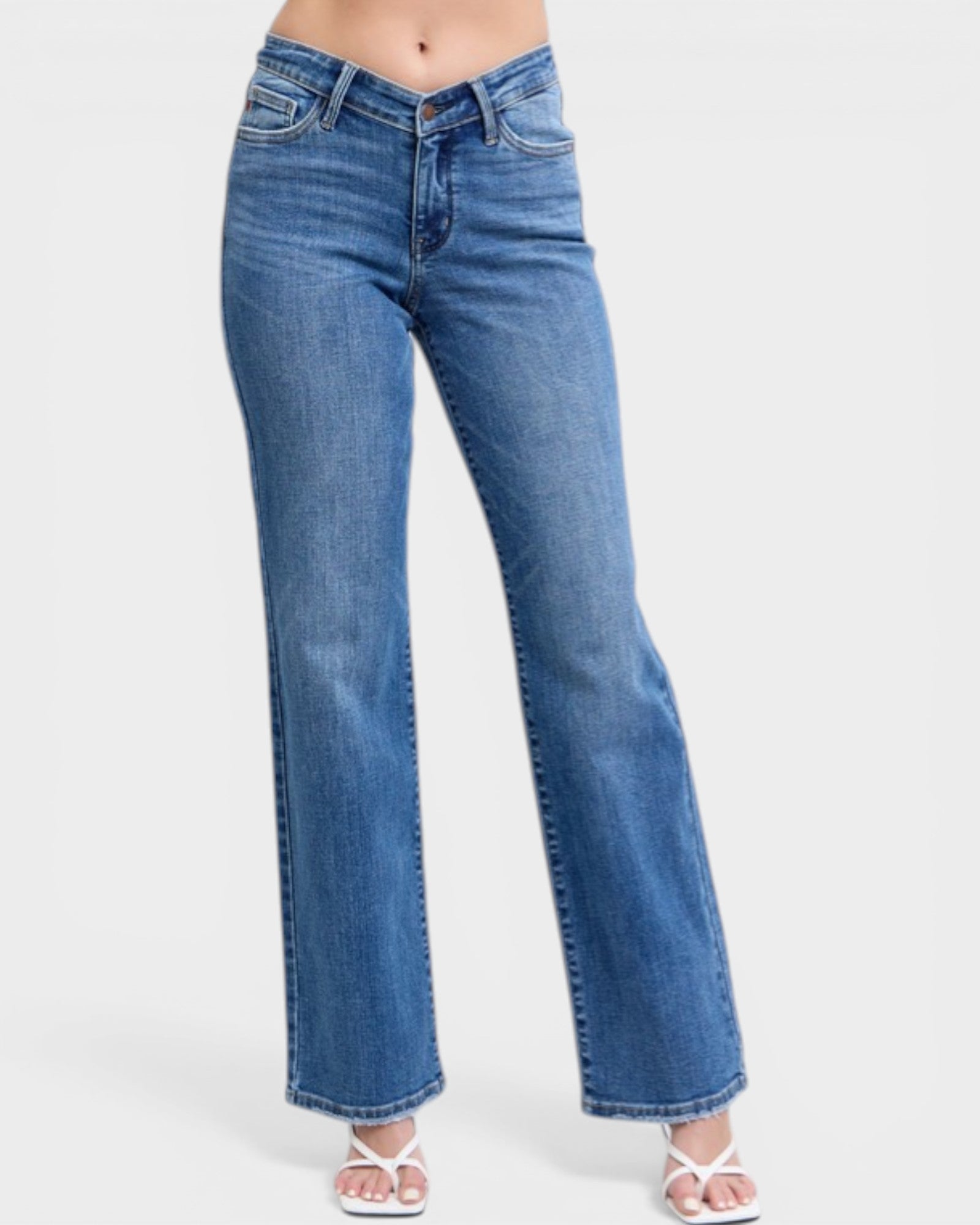 Blue jeans worn by a person on a white background