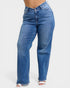 Blue jeans worn by a person on a white background