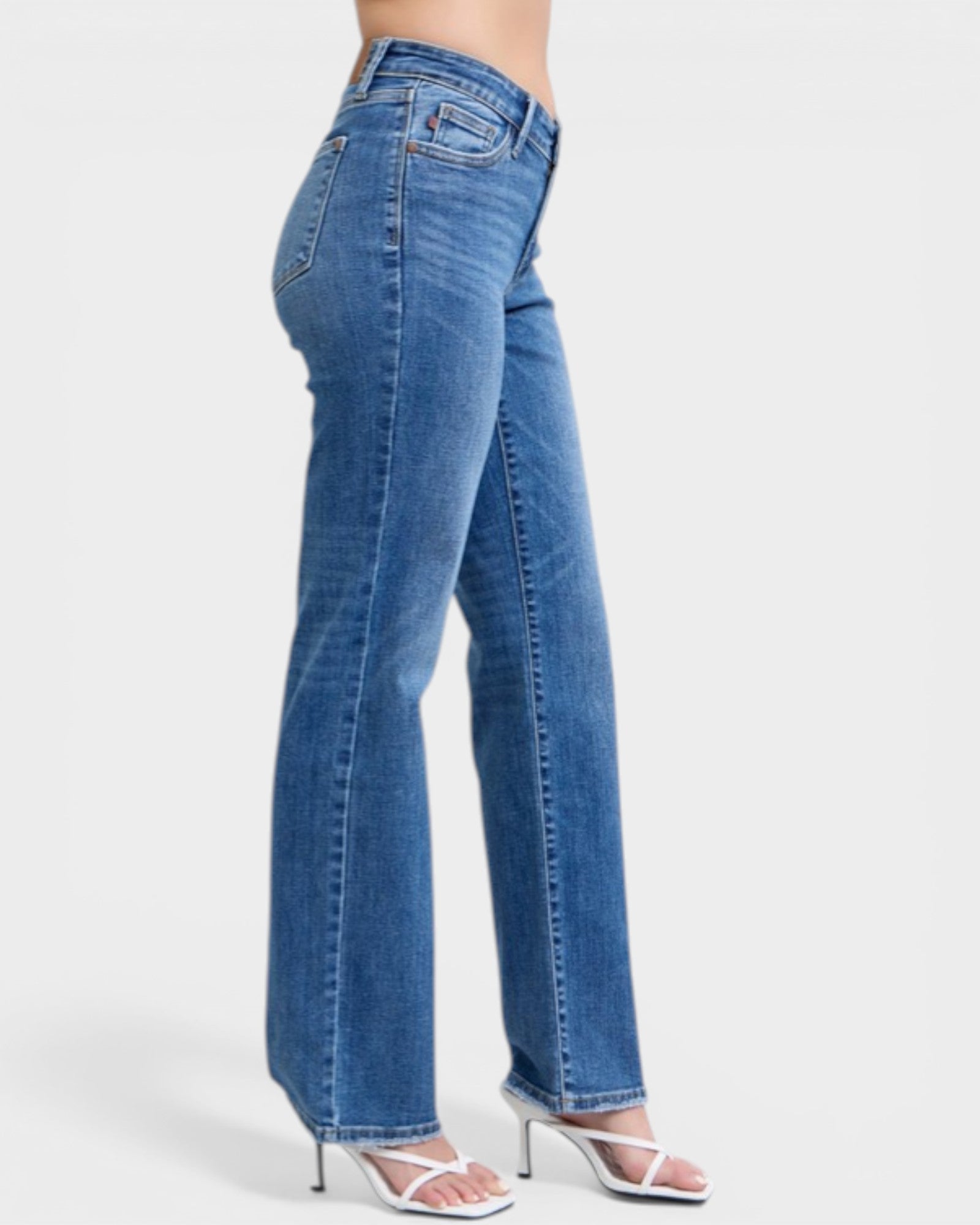 Blue jeans worn by a person on a white background