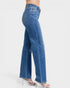 Blue jeans worn by a person on a white background
