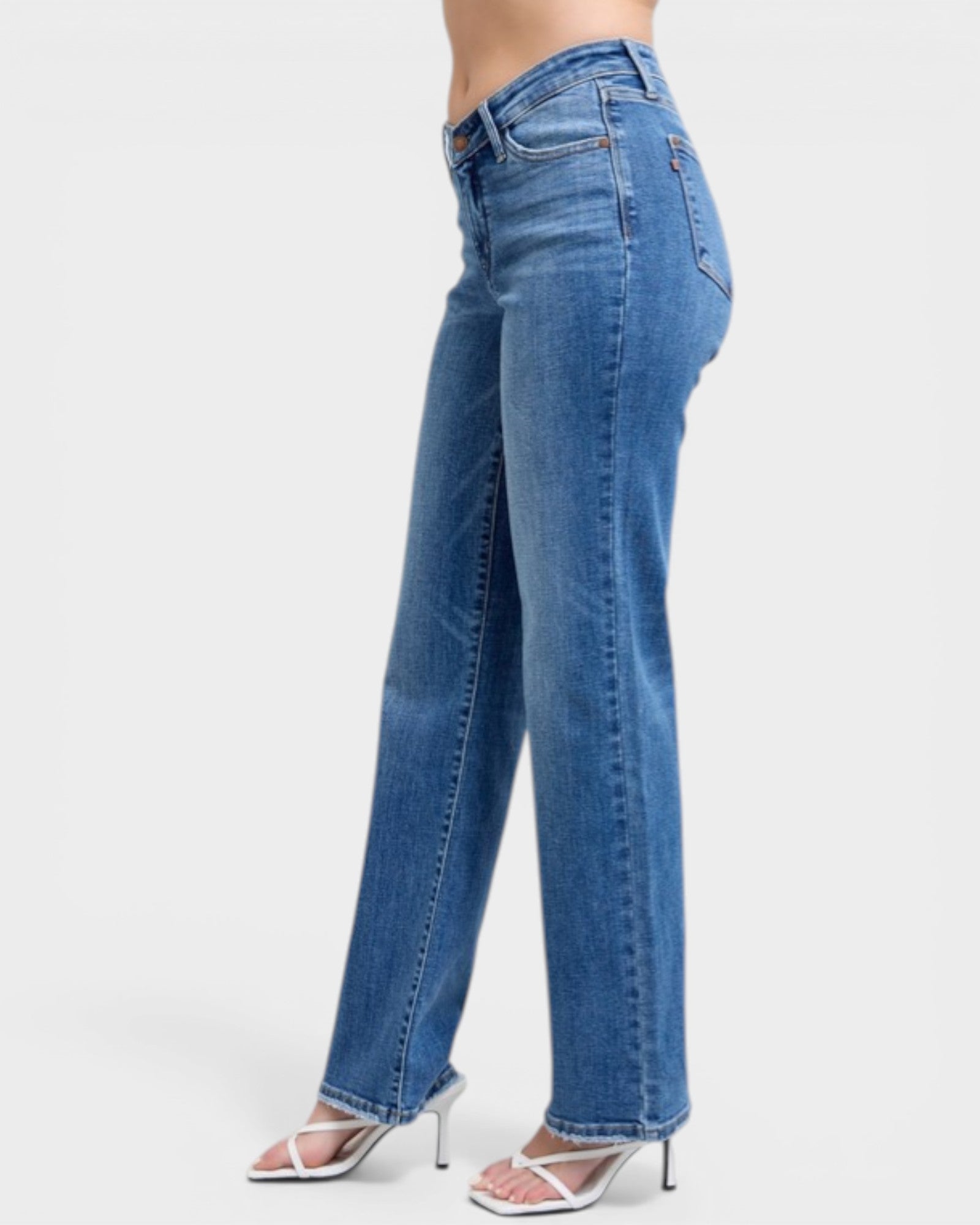 Blue jeans worn by a person on a white background