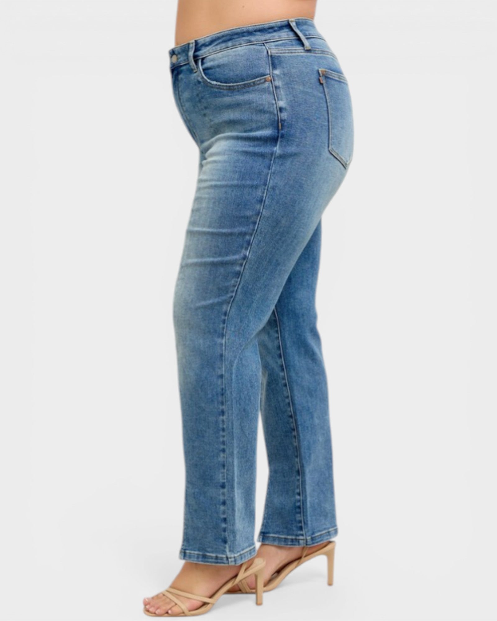 Blue jeans worn by a person on a white background