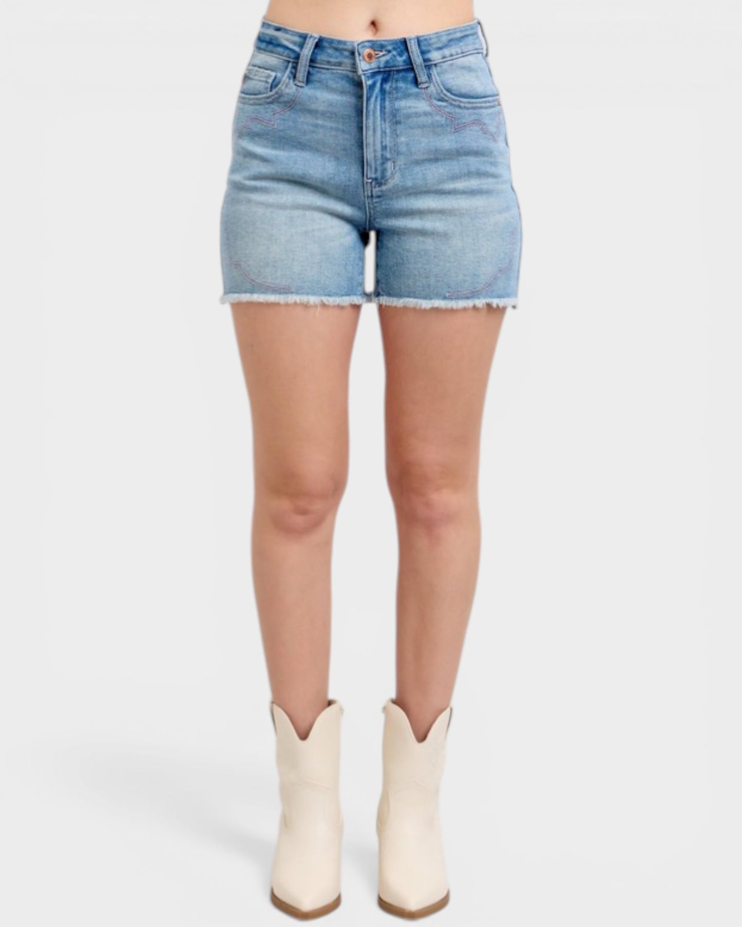 Denim shorts worn by a person on a white background