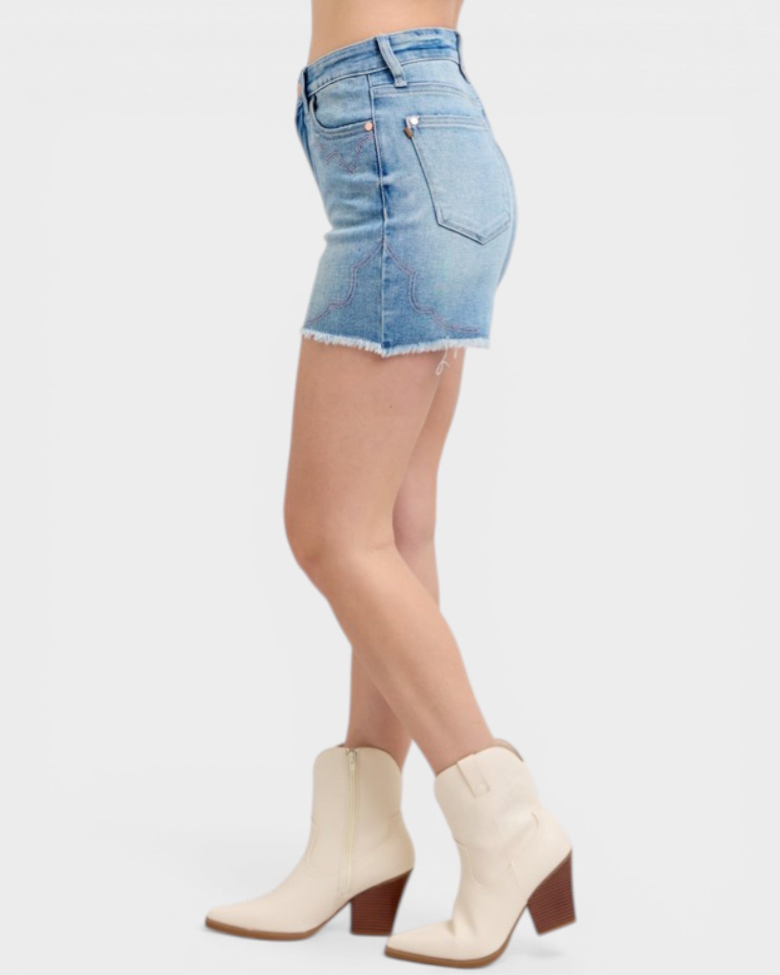 Denim skirt worn by a person on a white background