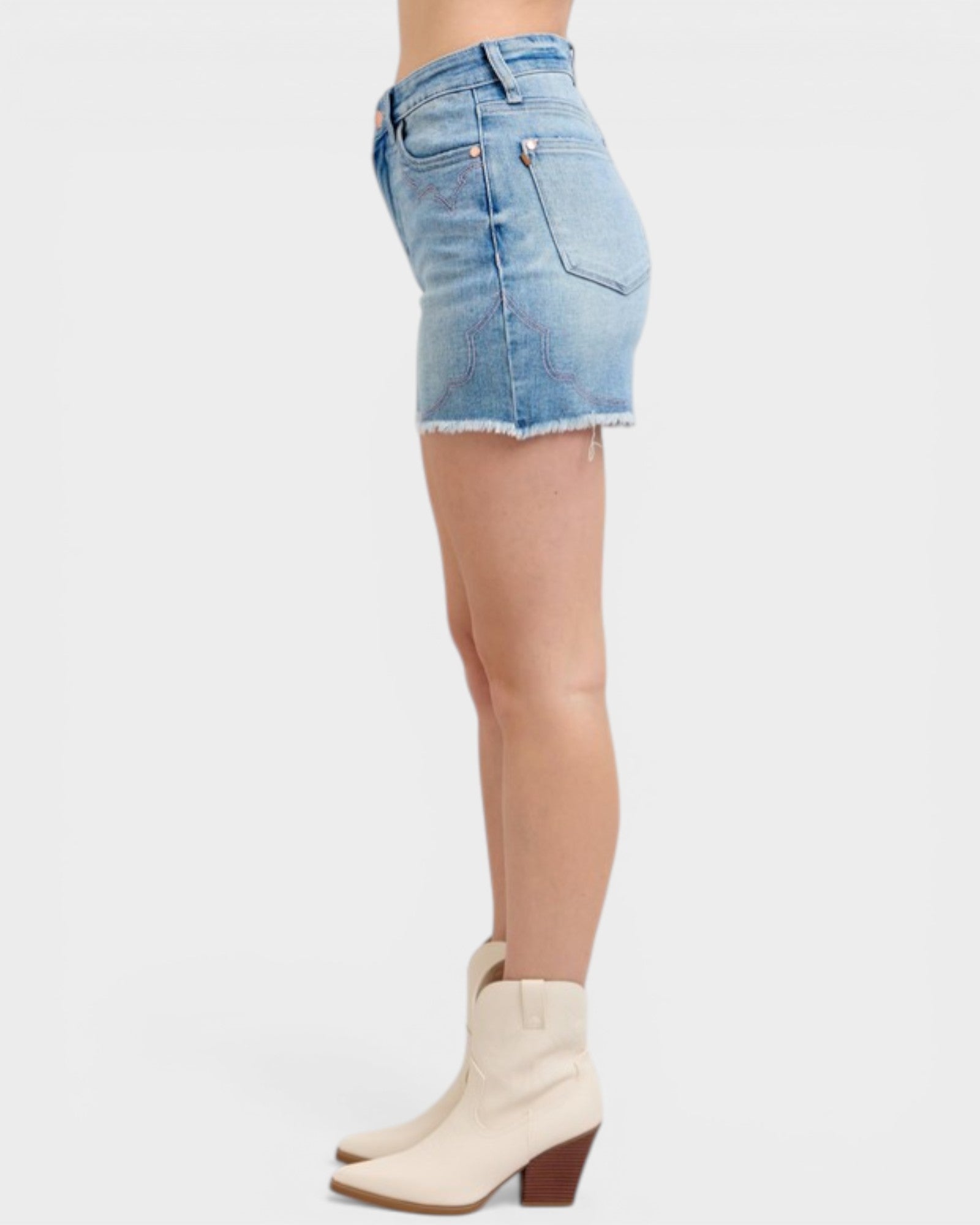 Denim skirt worn by a person on a white background