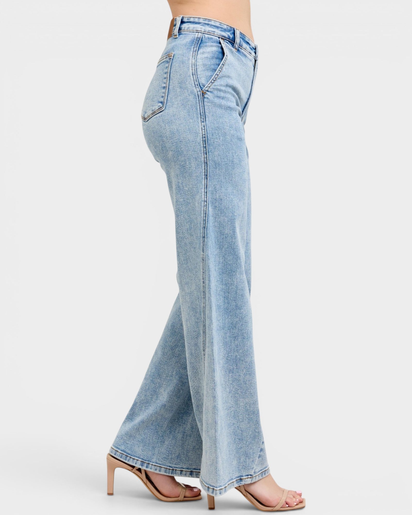 Light blue jeans worn by a person on a white background