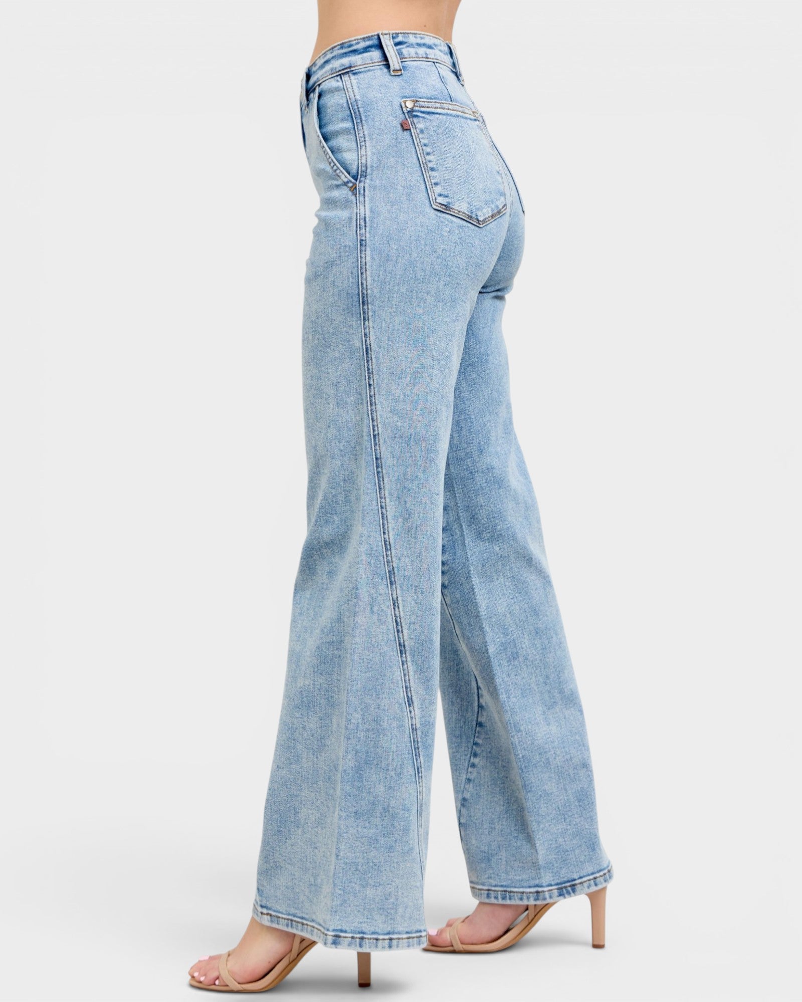 Light blue jeans worn by a person on a white background