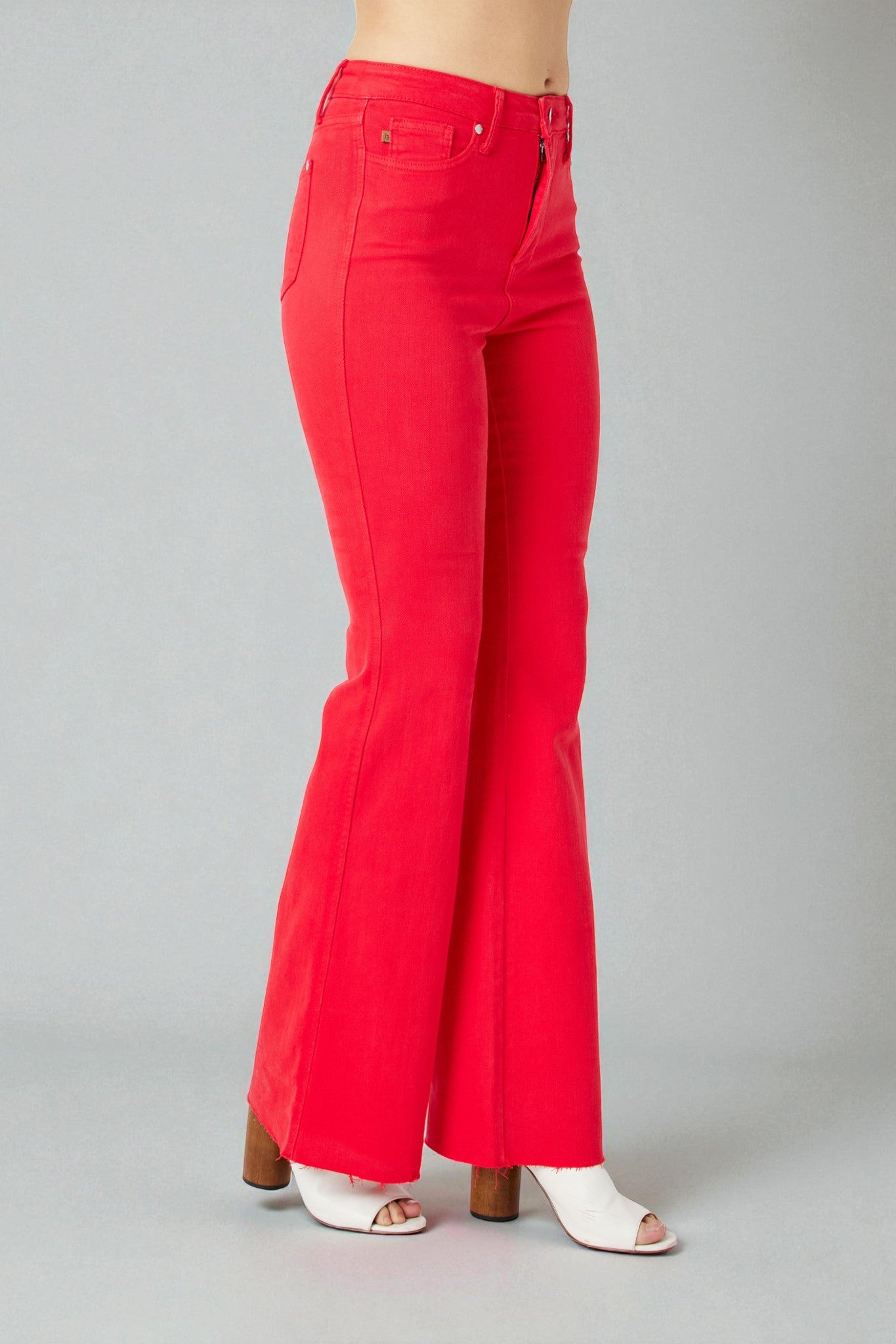 Red flared jeans on a gray background