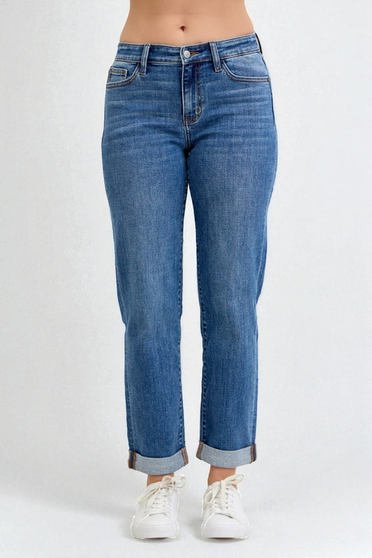 Blue jeans worn by a person on a white background