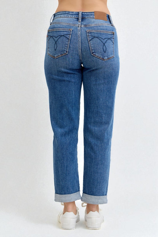 Blue jeans worn by a person on a white background