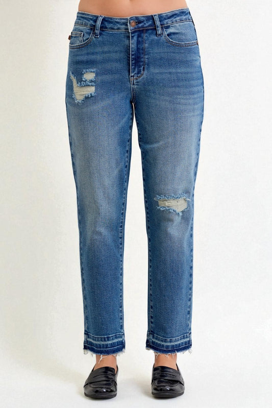 Blue jeans with slight distressing on a white background