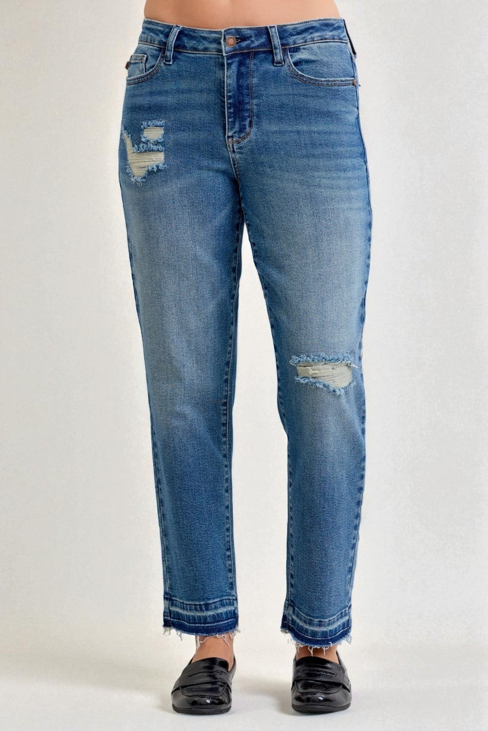 Blue jeans with slight distressing on a white background