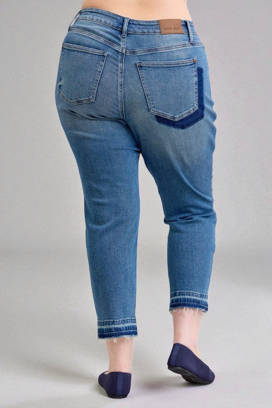 Blue jeans worn by a person on a gray background