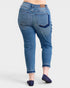 Blue jeans worn by a person on a white background