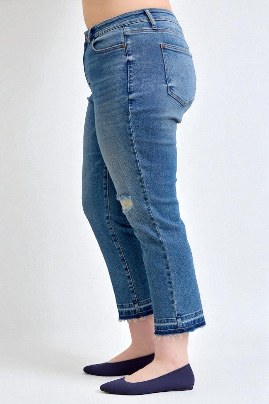 Blue jeans worn by a person on a white background