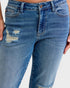 Close-up of blue jeans with a slight distressed look on a white background