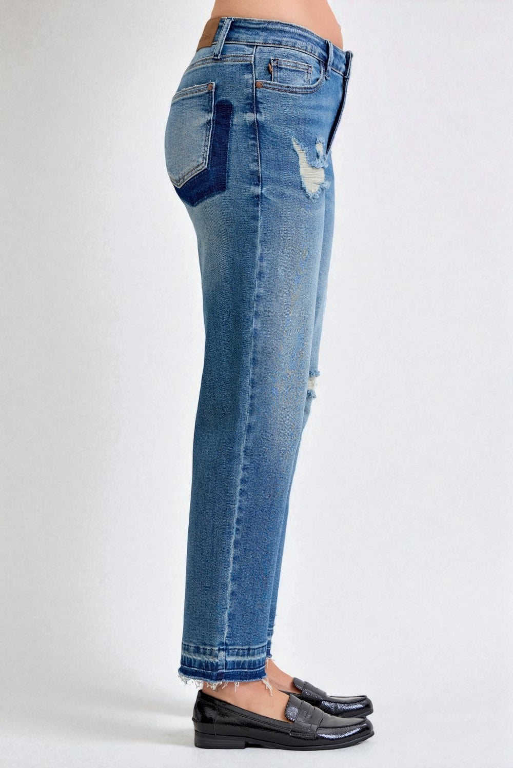 Blue jeans with patchwork design on a white background