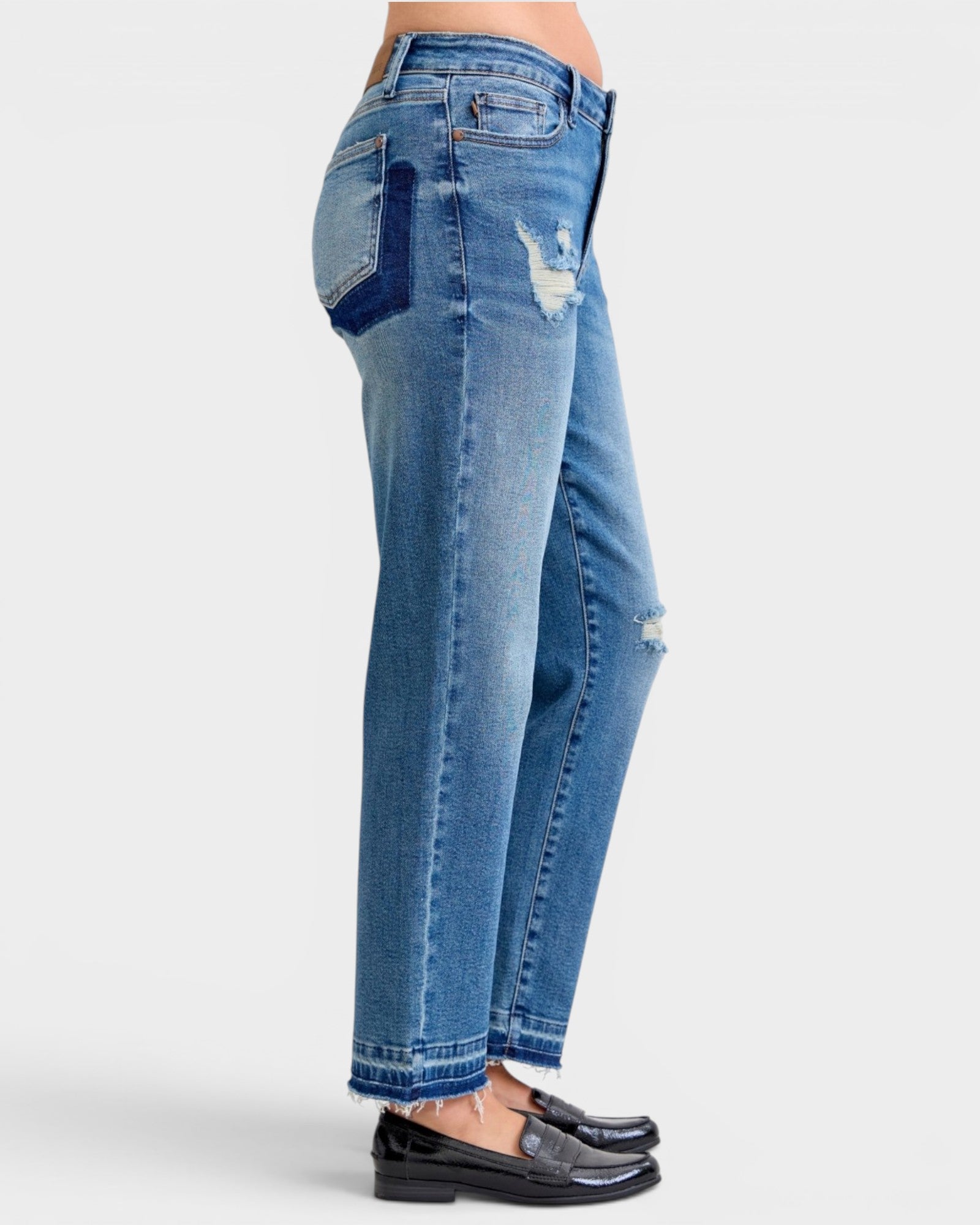 Blue jeans with patchwork design on a white background