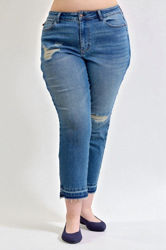 Blue jeans with distressed details on a white background