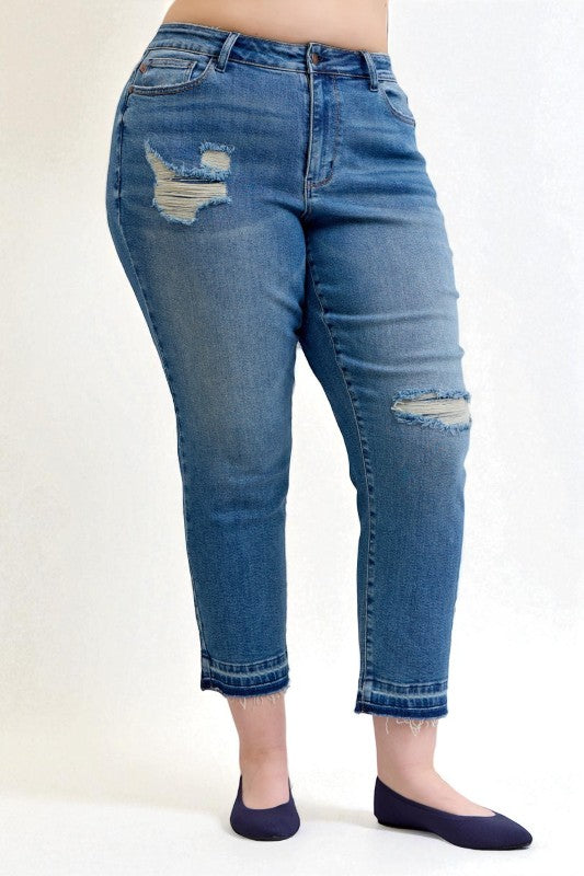 Blue jeans with distressing on a white background