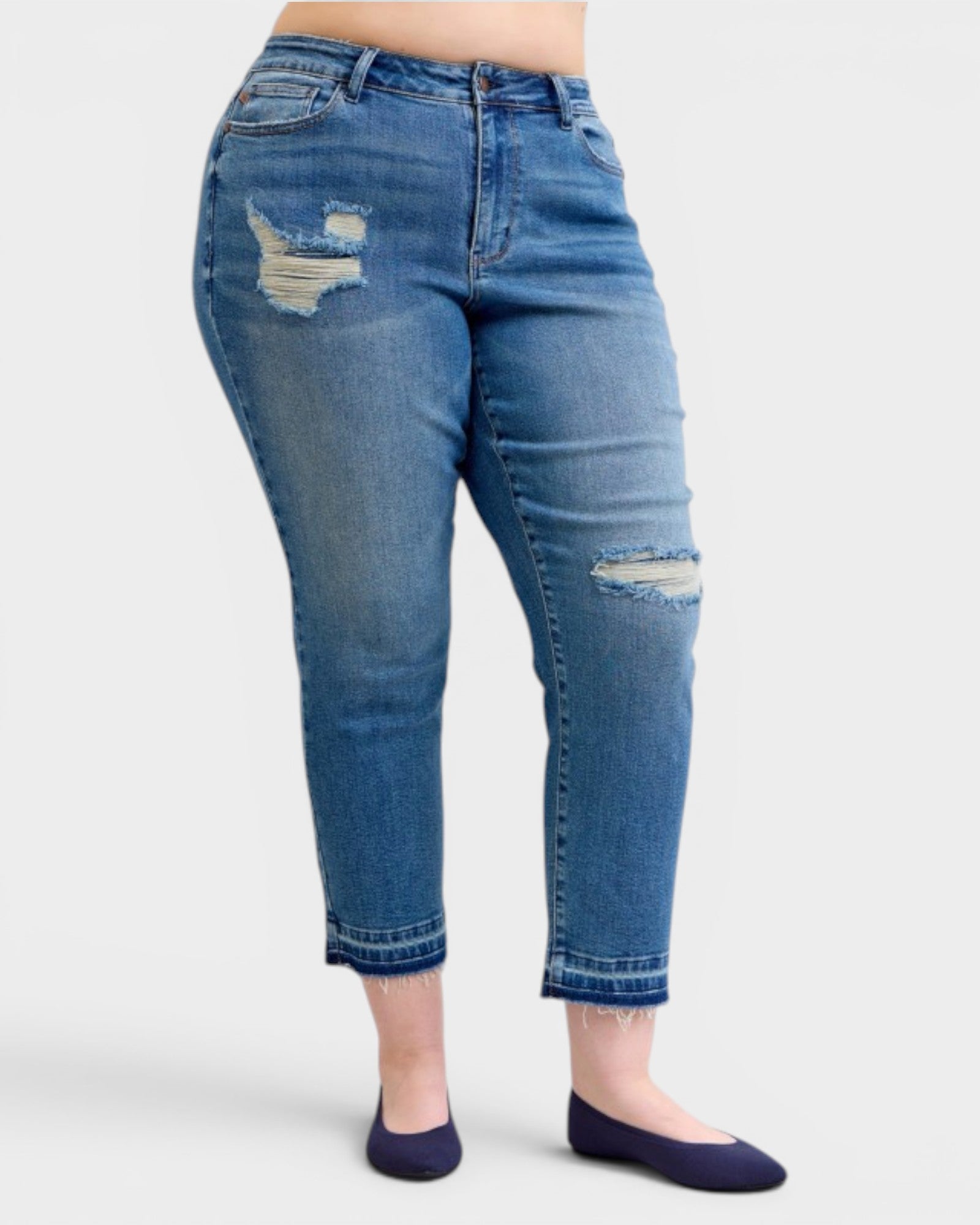 Blue jeans with distressing on a white background