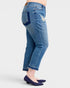 Blue jeans worn by a person on a white background