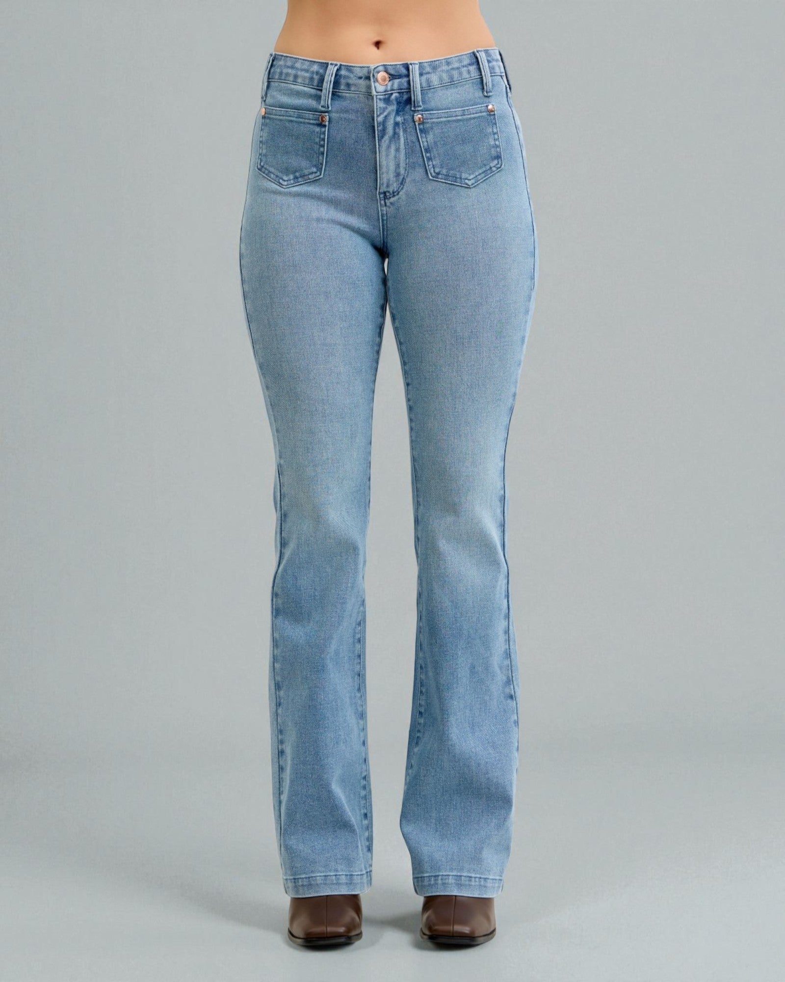 Light blue jeans worn by a person on a gray background