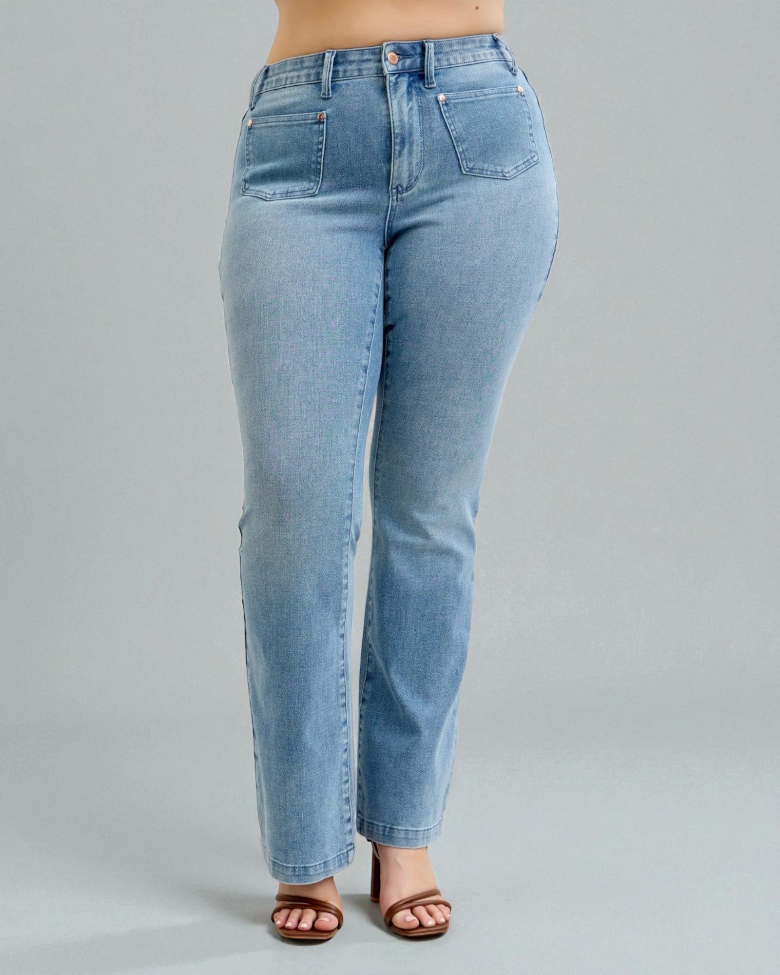Light blue jeans worn by a person on a gray background