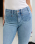 Light blue jeans worn by a person on a neutral background