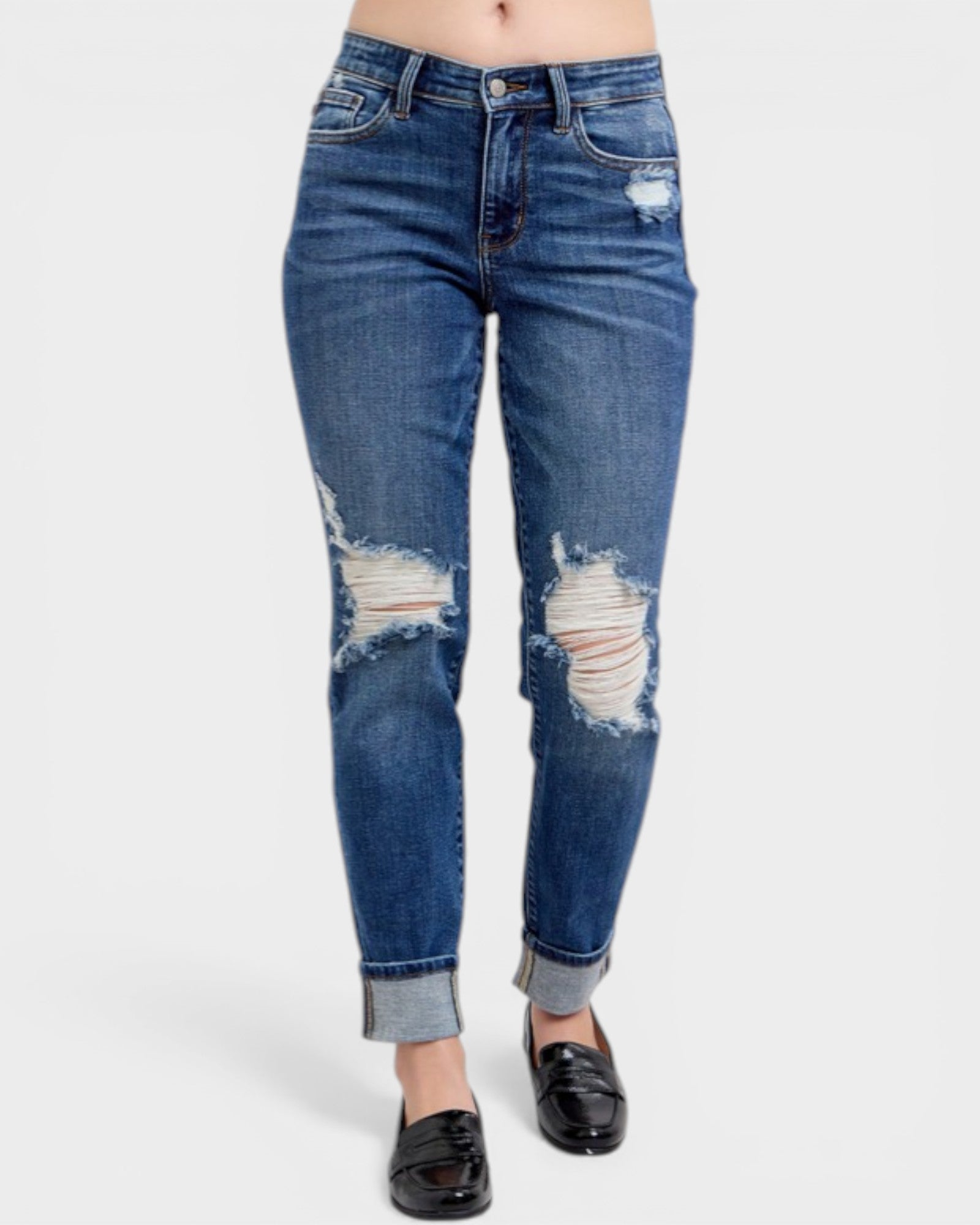 Distressed blue jeans on a white background